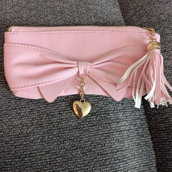 Charming Charlie Handbags - Chic Pink Bow Pouch with Tassel and Heart Charm